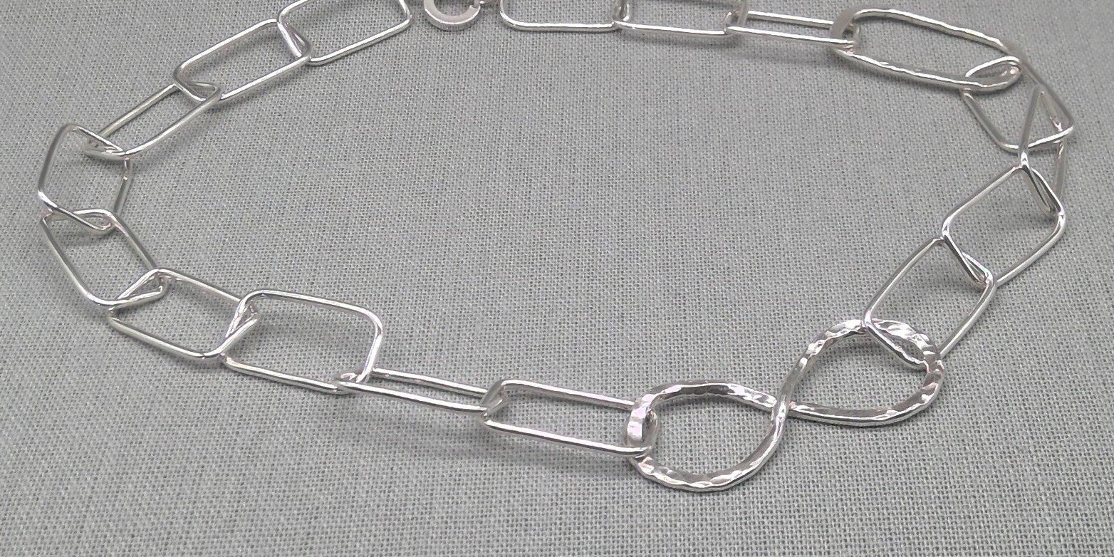 Infinity link recycled silver chain necklace laid flat, full view