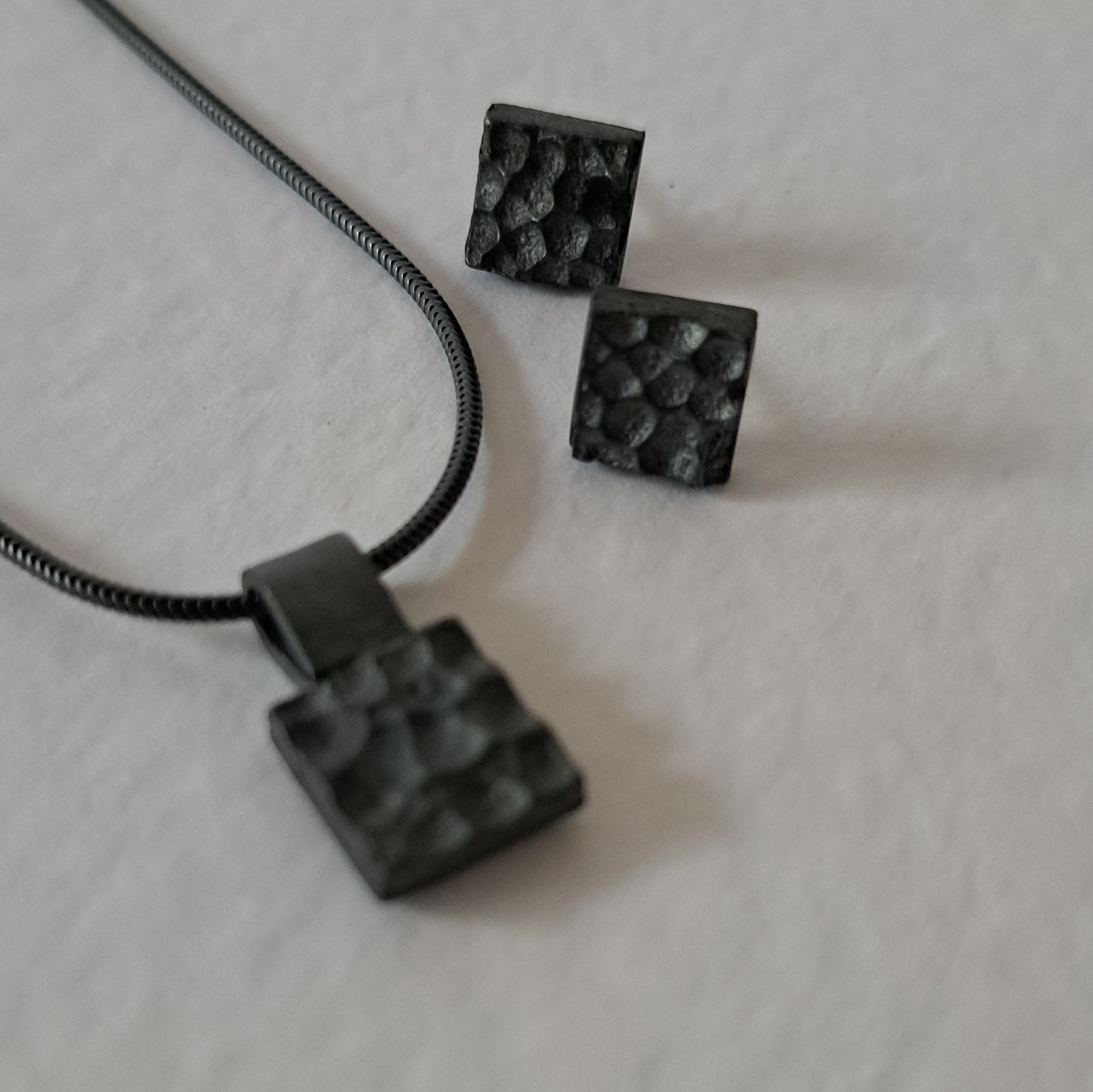 Handcrafted black oxidised sterling silver jewellery set featuring a sculptural pendant and matching stud earrings inspired by architecture and the SONYJA MINI Collection.