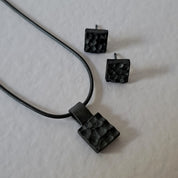 Handcrafted black oxidised sterling silver jewellery set featuring a sculptural pendant and matching stud earrings inspired by architecture and the SONYJA MINI Collection.