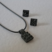 Handcrafted black oxidised sterling silver jewellery set featuring a sculptural pendant and matching stud earrings inspired by architecture and the SONYJA MINI Collection.