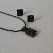 Handcrafted black oxidised sterling silver jewellery set featuring a sculptural pendant and matching stud earrings inspired by architecture and the SONYJA MINI Collection.