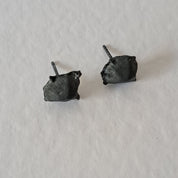 Handcrafted Futurist Brutalist Pebble Stud Earrings in black oxidised sterling silver featuring an organic sculptural texture inspired by architecture and natural stone.