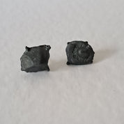 Handcrafted Futurist Brutalist Pebble Stud Earrings in black oxidised sterling silver featuring an organic sculptural texture inspired by architecture and natural stone.