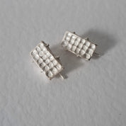 Handcrafted sculptural sterling silver stud earrings from the SONYJA MINI Collection with textured geometric design.