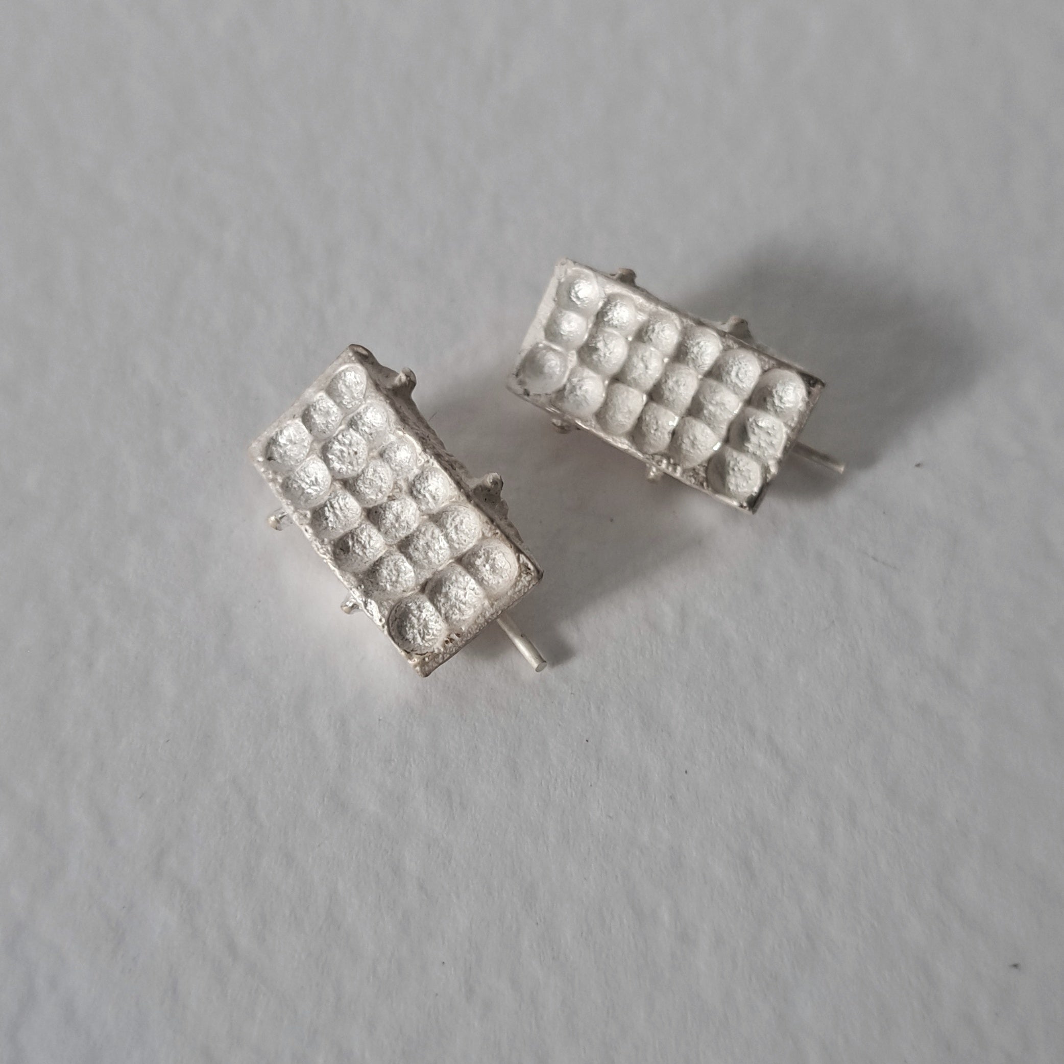 Handcrafted sculptural sterling silver stud earrings from the SONYJA MINI Collection with textured geometric design.