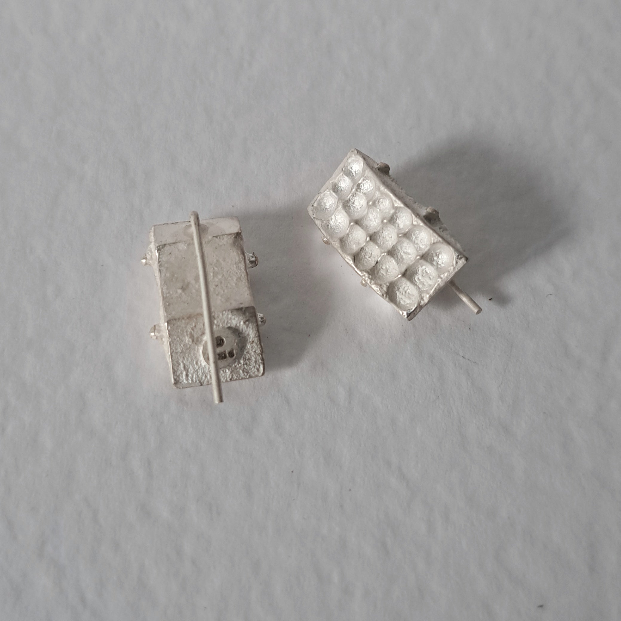 Handcrafted sculptural sterling silver stud earrings from the SONYJA MINI Collection with textured geometric design.