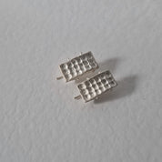 Handcrafted sculptural sterling silver stud earrings from the SONYJA MINI Collection with textured geometric design.