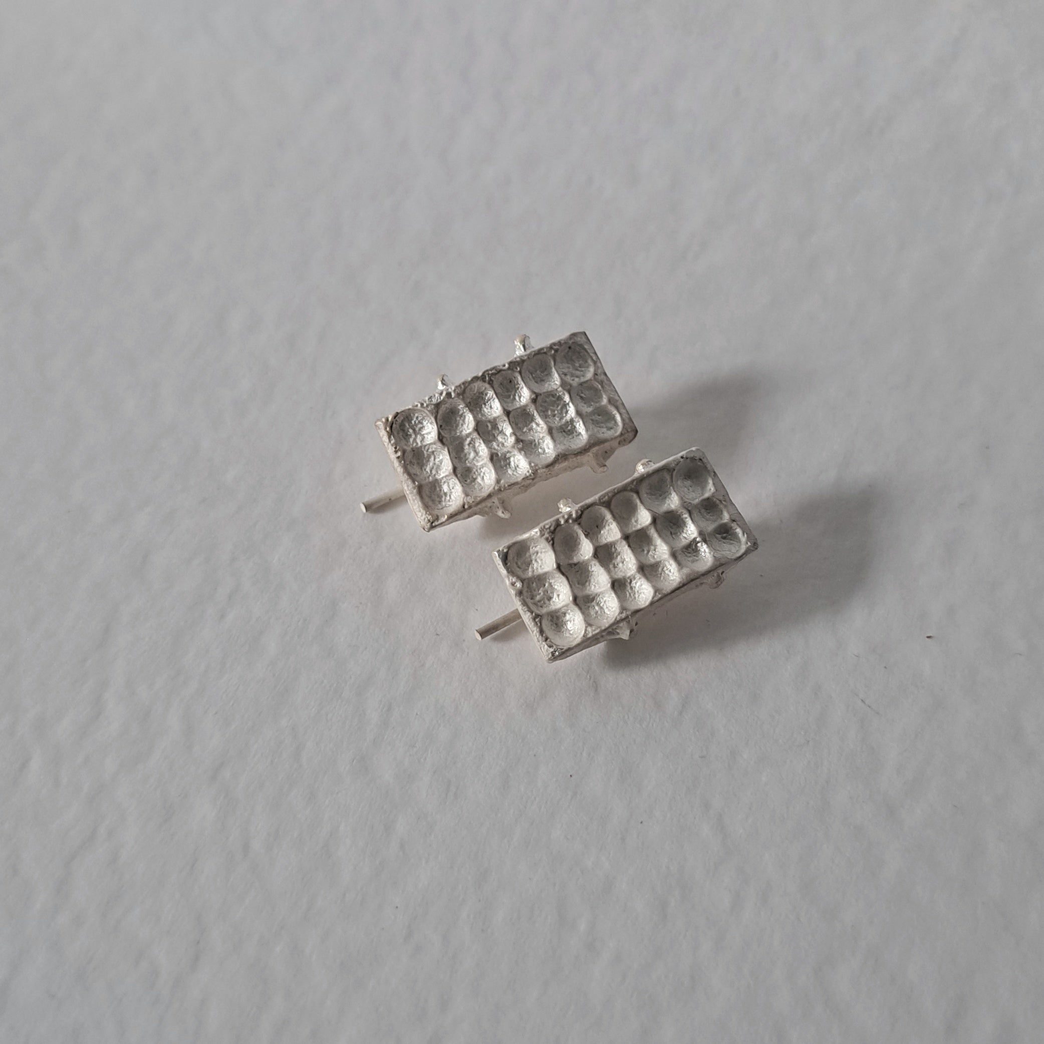 Handcrafted sculptural sterling silver stud earrings from the SONYJA MINI Collection with textured geometric design.