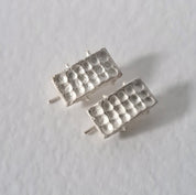 Handcrafted sculptural sterling silver stud earrings from the SONYJA MINI Collection with textured geometric design.
