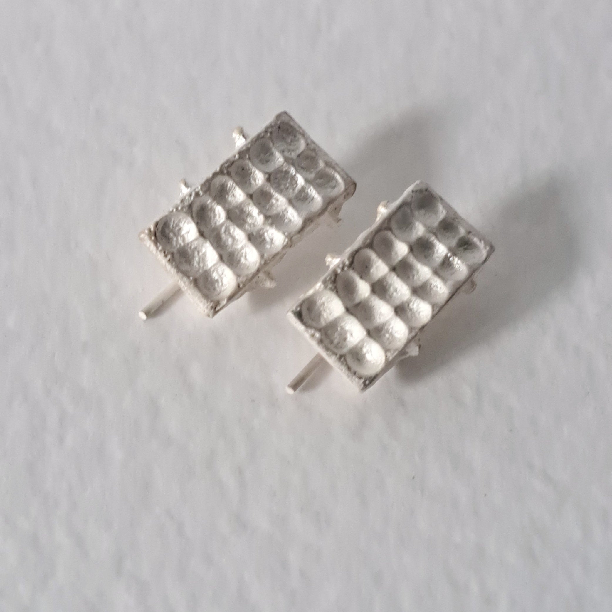 Handcrafted sculptural sterling silver stud earrings from the SONYJA MINI Collection with textured geometric design.