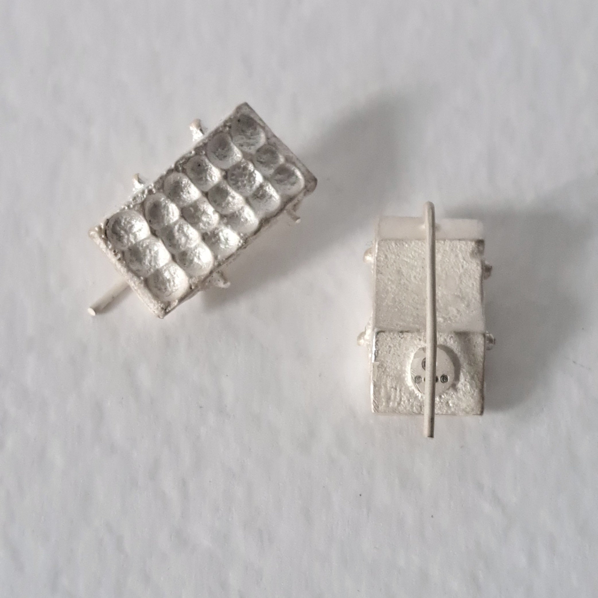 Handcrafted sculptural sterling silver stud earrings from the SONYJA MINI Collection with textured geometric design.