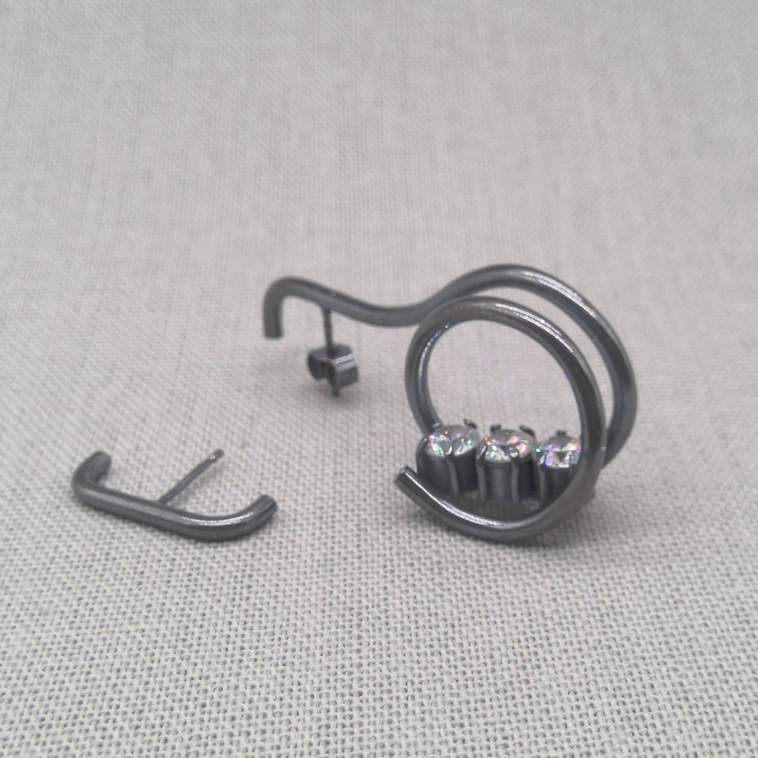 Back view of asymmetrical oxidized silver earring pair