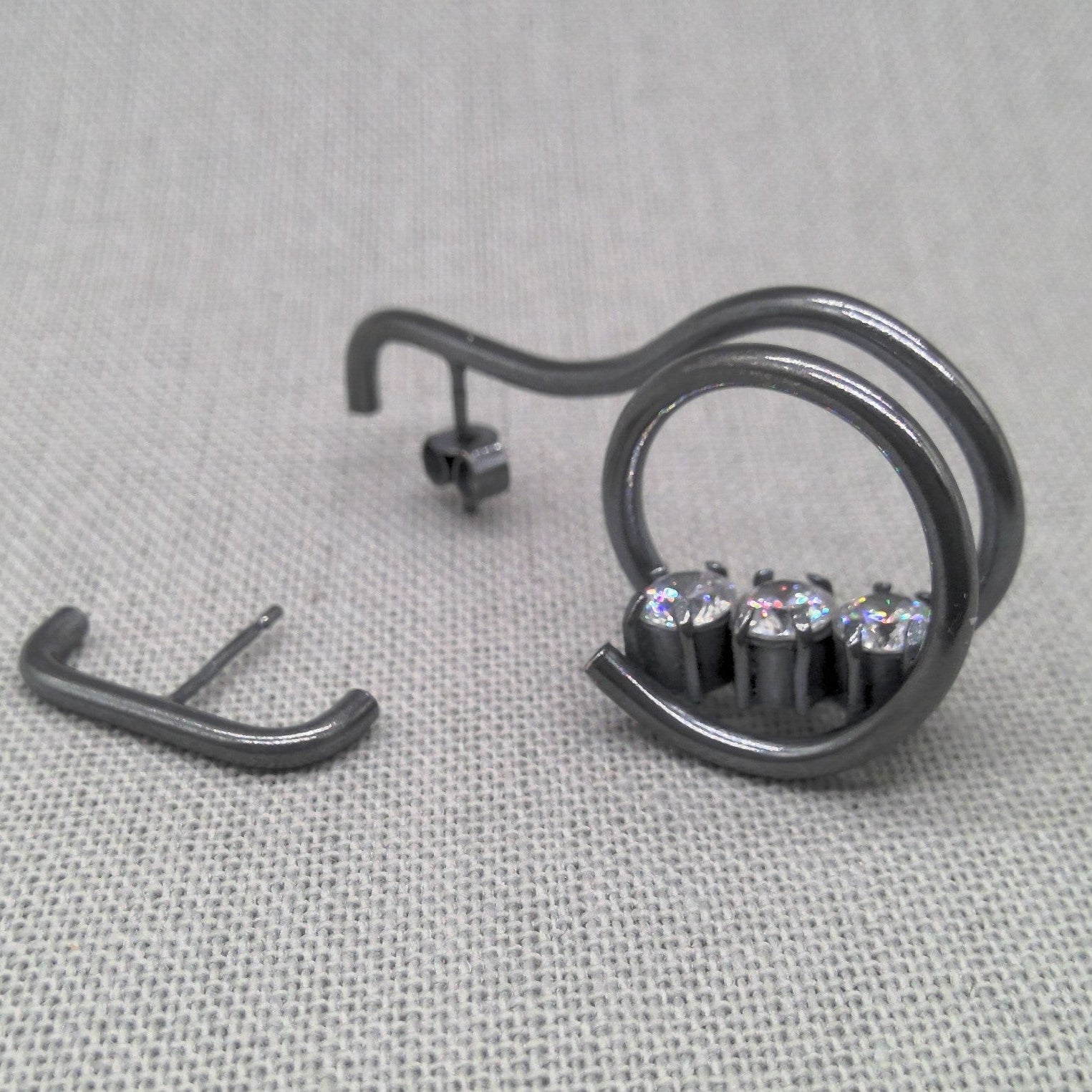 Close-up of zircon stone detail on oxidized recycled silver earring