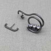 Front view of asymmetrical oxidized silver earrings set with zircons