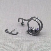 Side detail shot of asymmetrical recycled silver zircon earrings