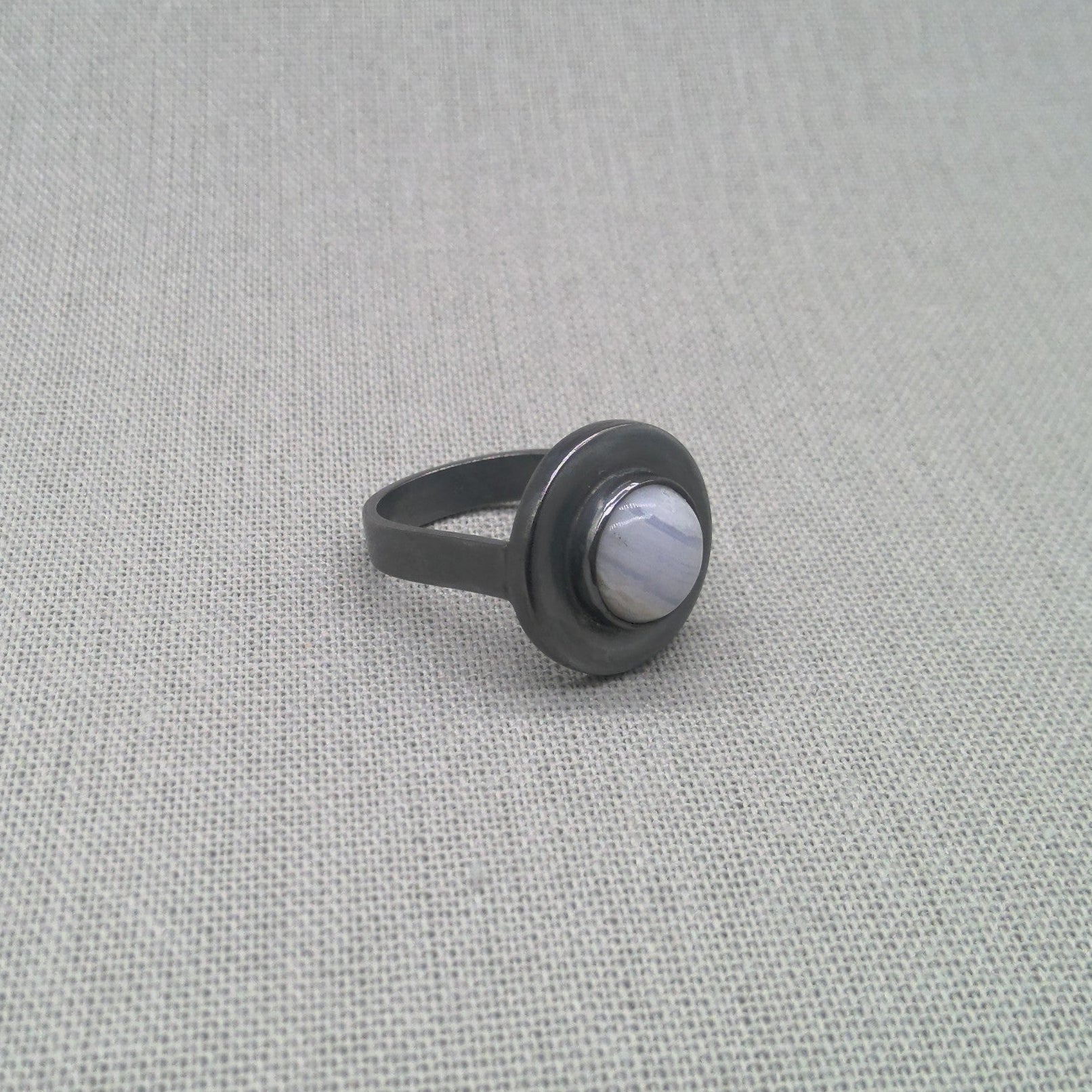 Angled view of oxidised blue lace agate recycled silver ring