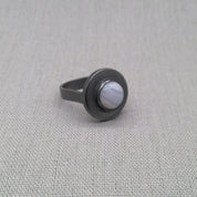 Top-down view of blue lace agate cabochon in silver setting