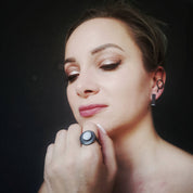 Close-up of model wearing oxidised blue lace agate silver ring