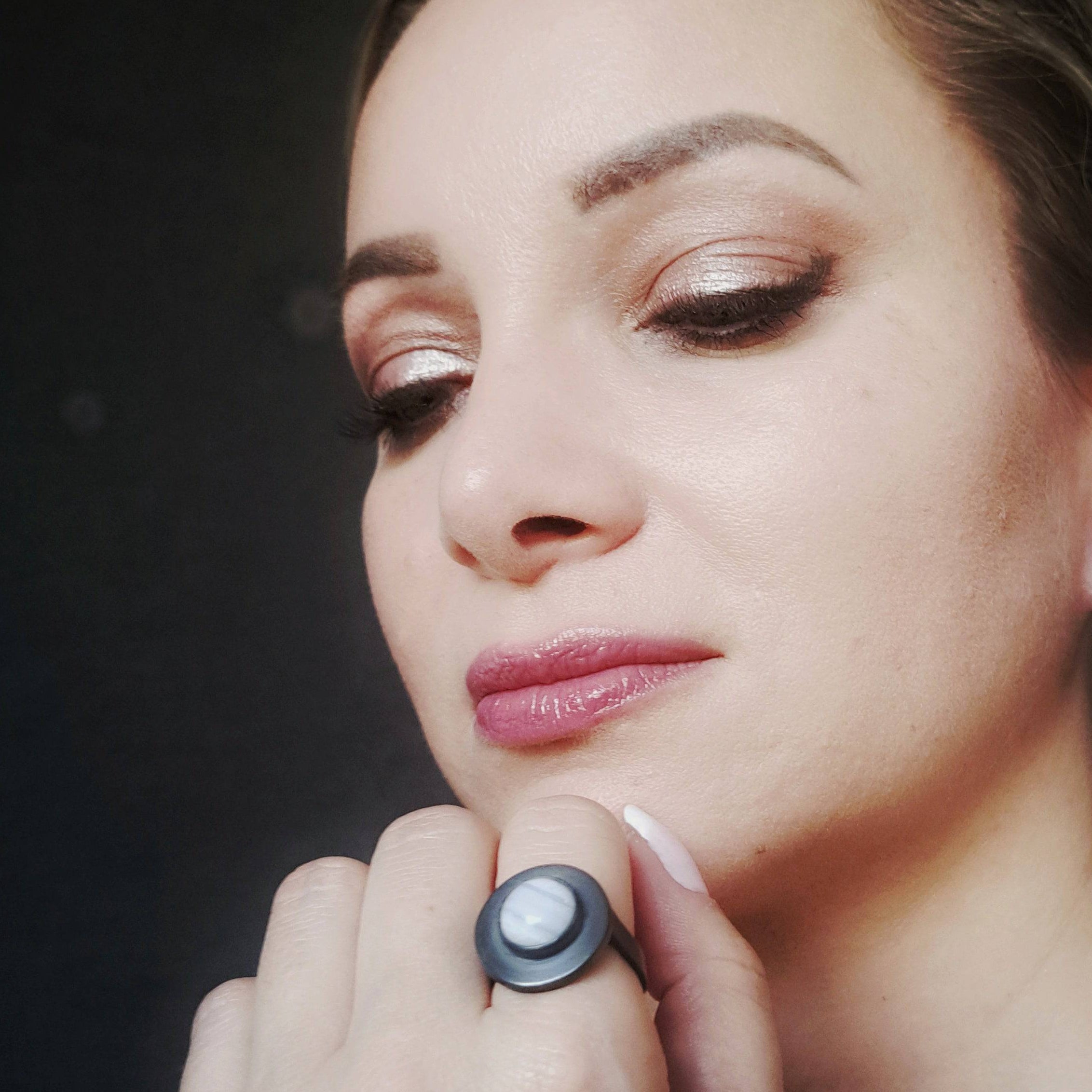 Close-up of model wearing oxidised blue lace agate silver ring