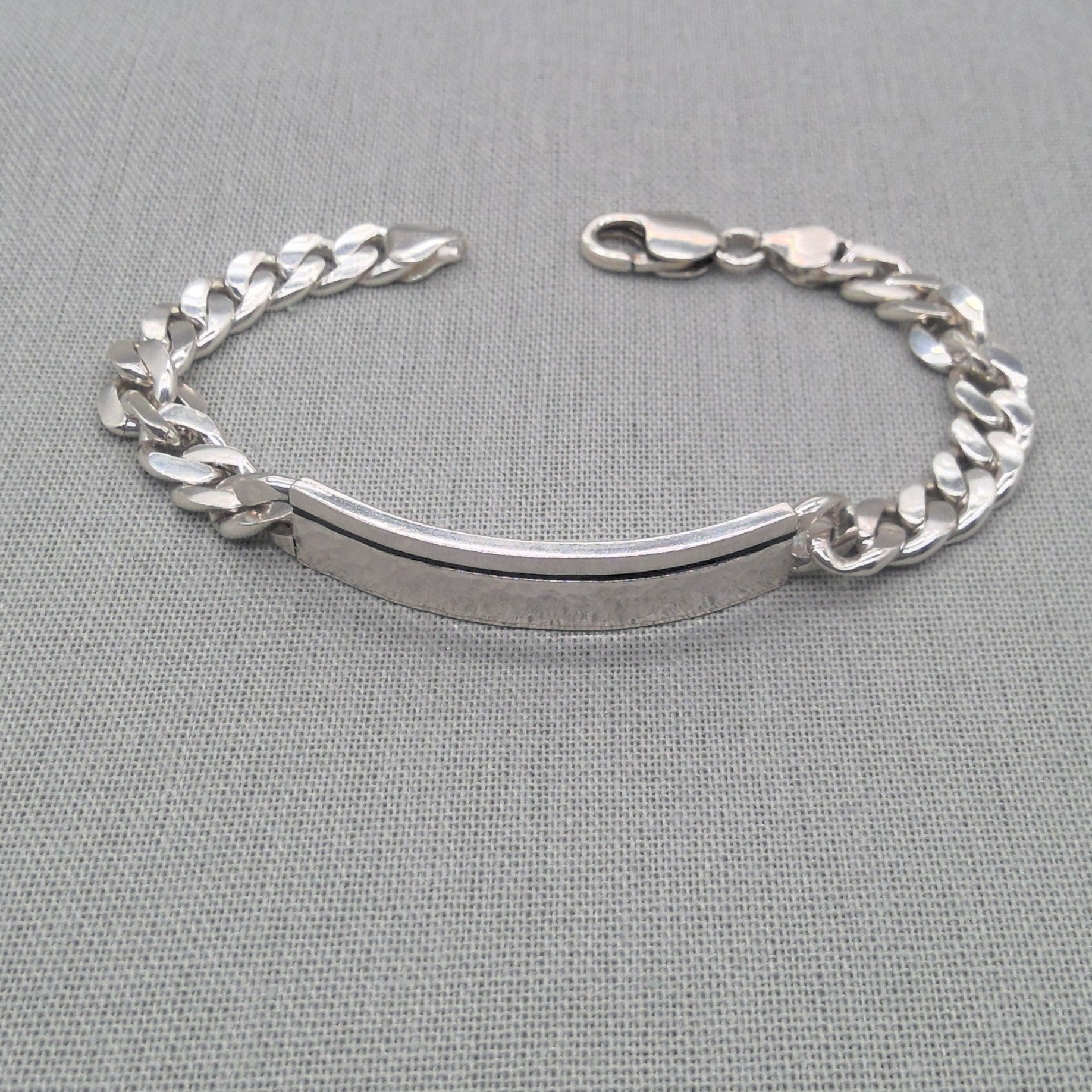 Chunky recycled silver curb chain ID bracelet with clasp on fabric