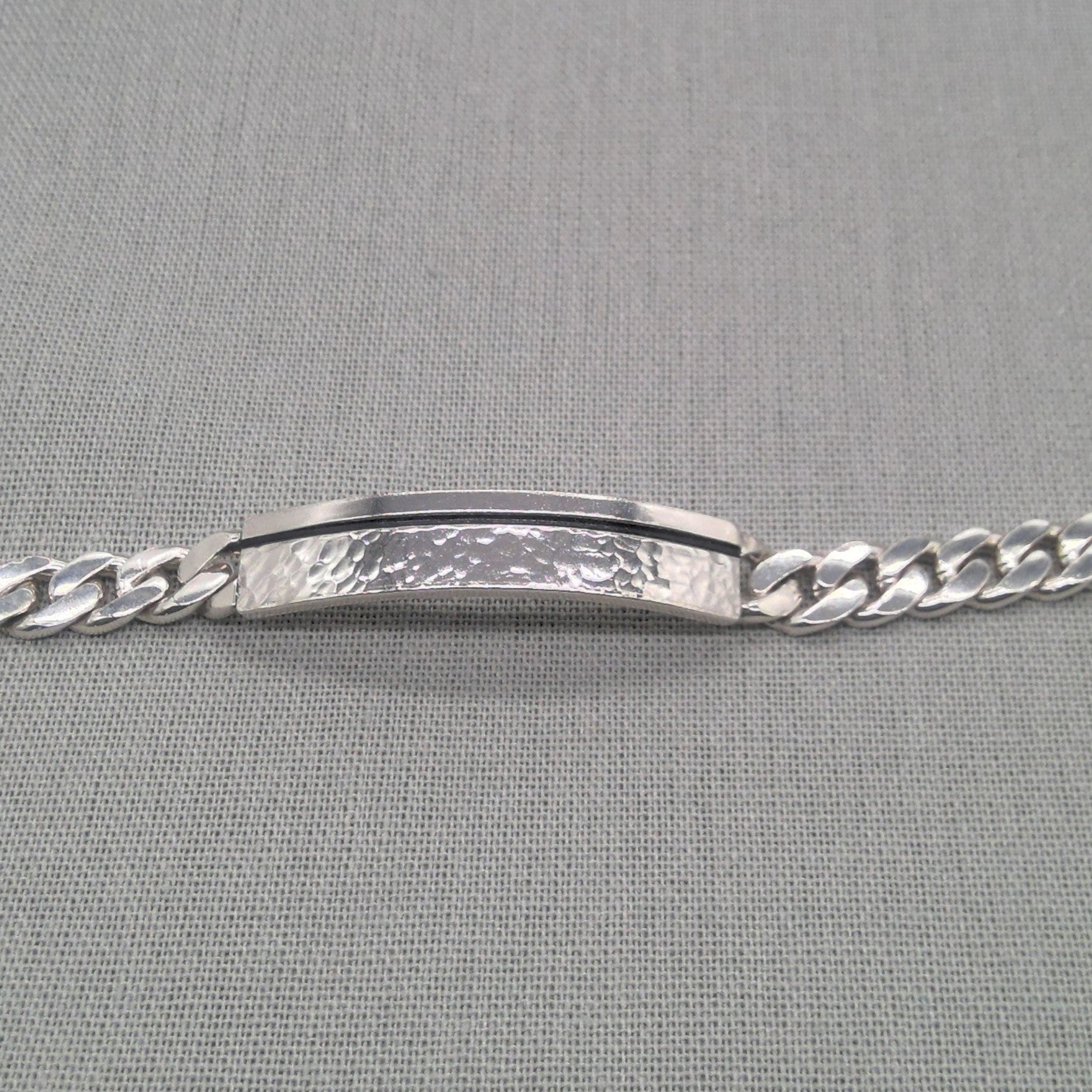 Front view of recycled silver ID bracelet showing hammered plaque