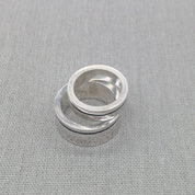 Top-down view of stacked chunky recycled silver wedding rings
