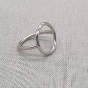 Side profile of polished silver circle ring showing geometric shape