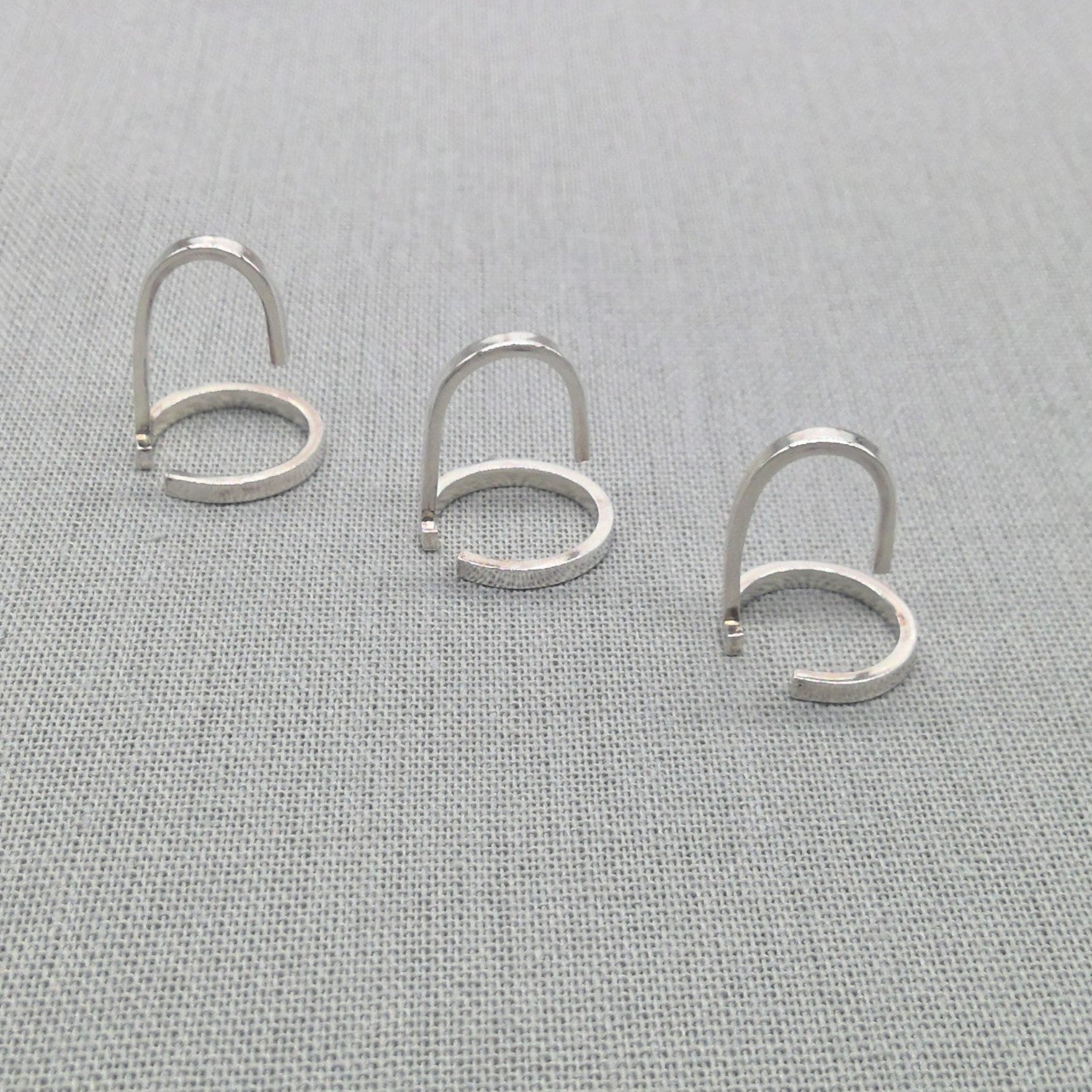 Alternate flat lay of Gladiator collection silver wrap rings