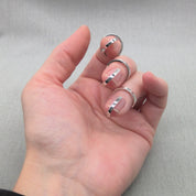 Side view of hand wearing Gladiator collection silver rings