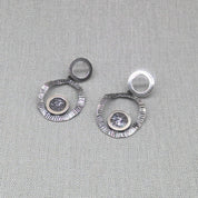 Close-up of zircon and resin centre on hammered silver earring