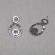 Side detail of hammered silver earring showing hook and circles