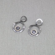 Hammered recycled silver double circle earrings with zircon centre on fabric