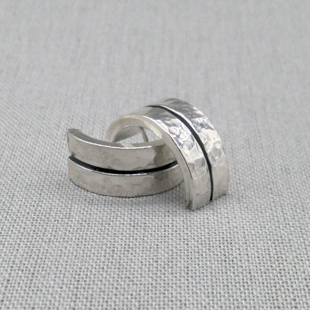 Hammered recycled silver ear cuffs with black accent line on fabric