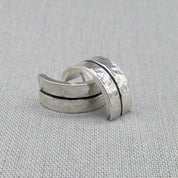 Hammered recycled silver ear cuffs with black accent line on fabric
