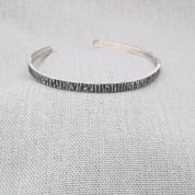 Front view of open hammered silver cuff bangle