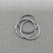 Top-down view of interlocking hammered silver ring bands
