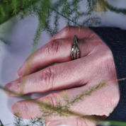 Triple band hammered silver ring worn on hand outdoors