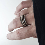 Hammered silver spinner ring worn stacked on fingers