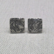 Textured hammered square recycled silver stud earrings on fabric