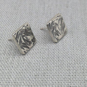 Detail shot of hammered square stud earring showing silver texture
