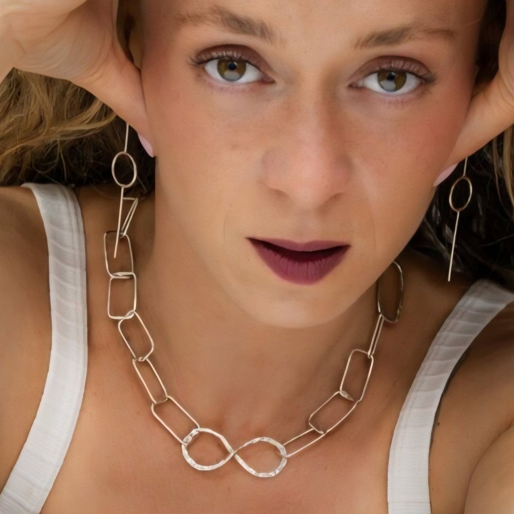 Model wearing the infinity link recycled silver chain necklace