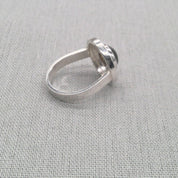 Angled view of sculptural labradorite silver ring band
