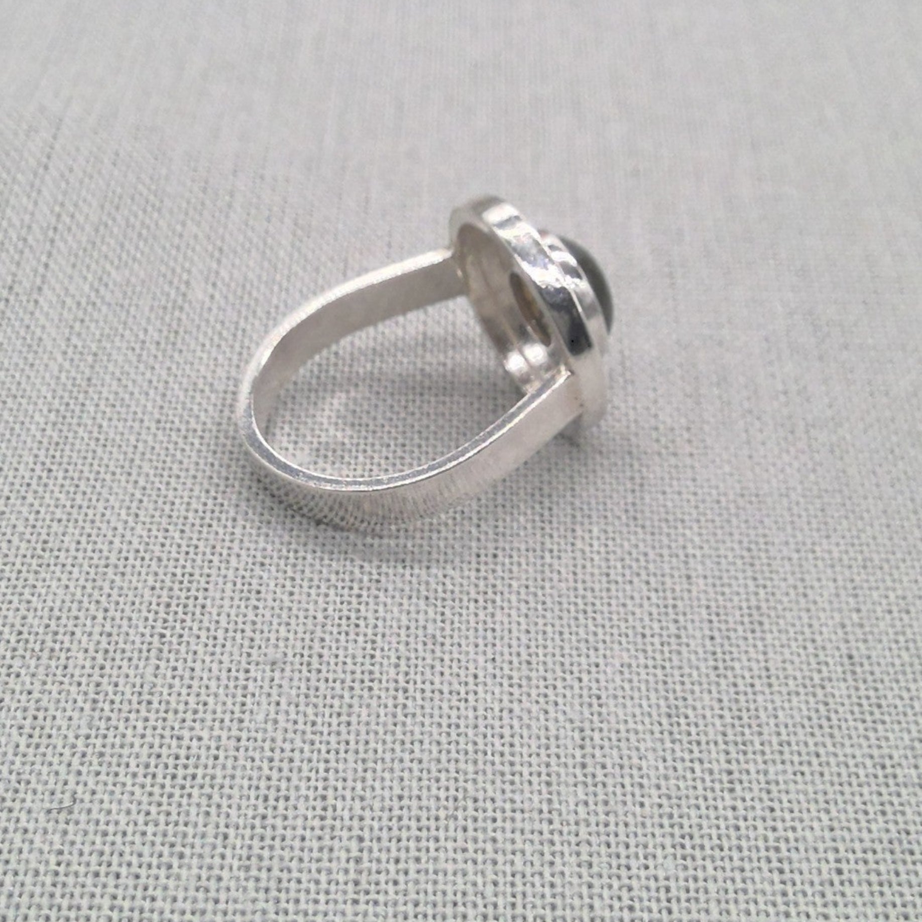 Angled view of sculptural labradorite silver ring band