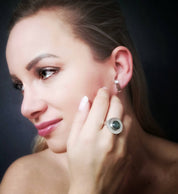 Close-up of labradorite silver ring worn on model's hand