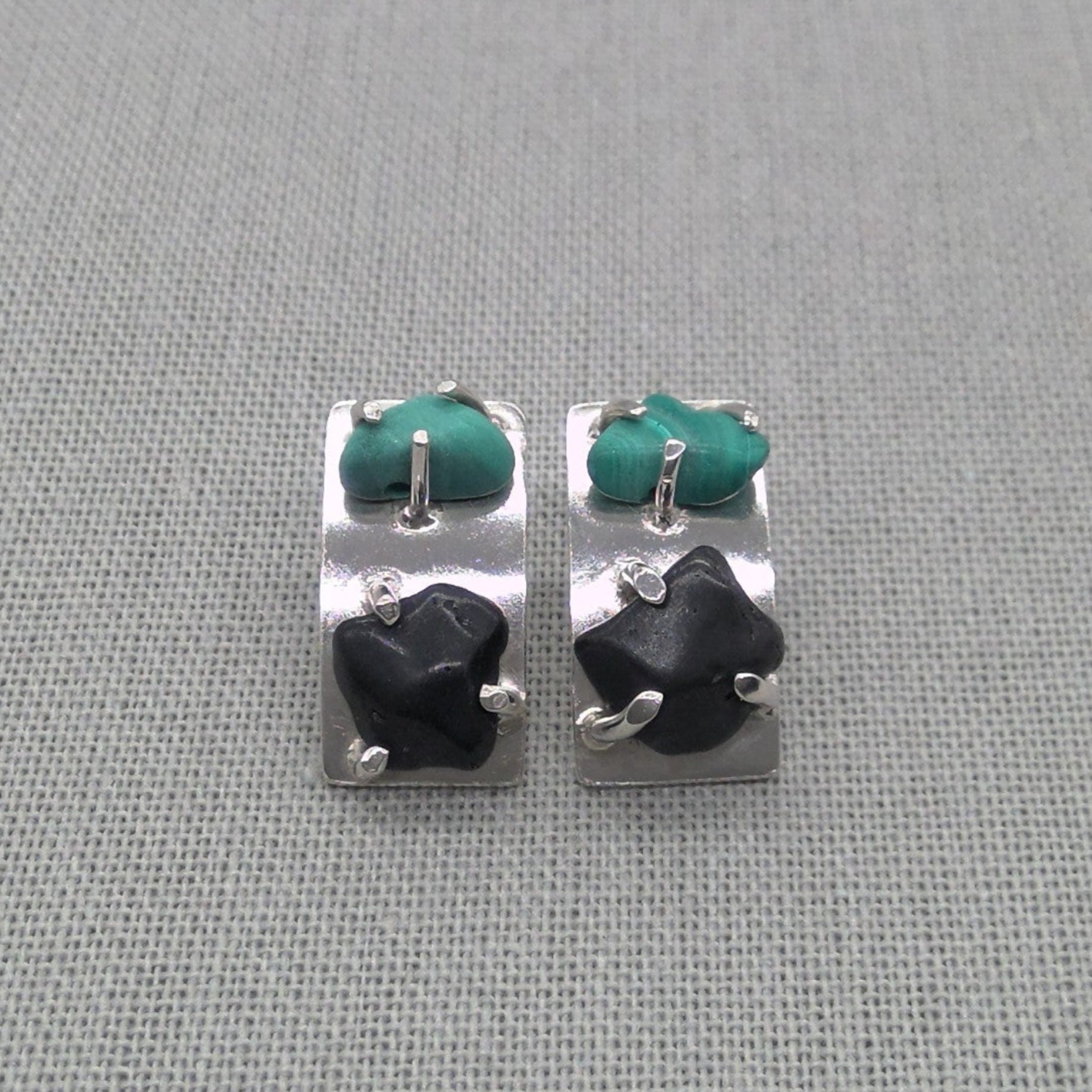 Front view of malachite and obsidian silver stud earrings
