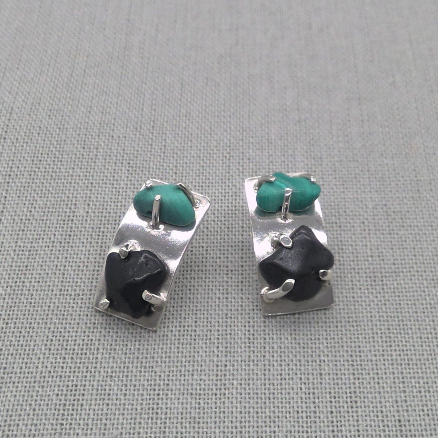Side view of malachite and obsidian recycled silver earrings