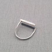 Close-up angled shot of recycled silver ring highlighting square wire frame