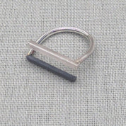Minimalist recycled silver ring with square and round wire design on fabric