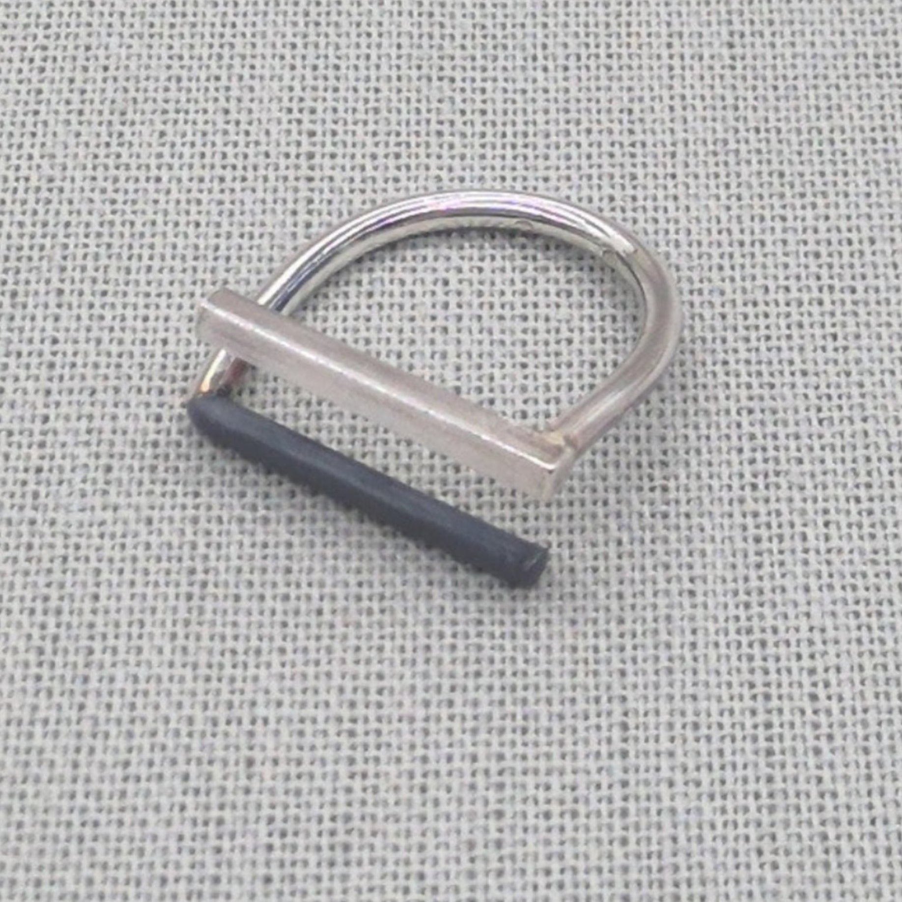 Minimalist recycled silver ring with square and round wire design on fabric