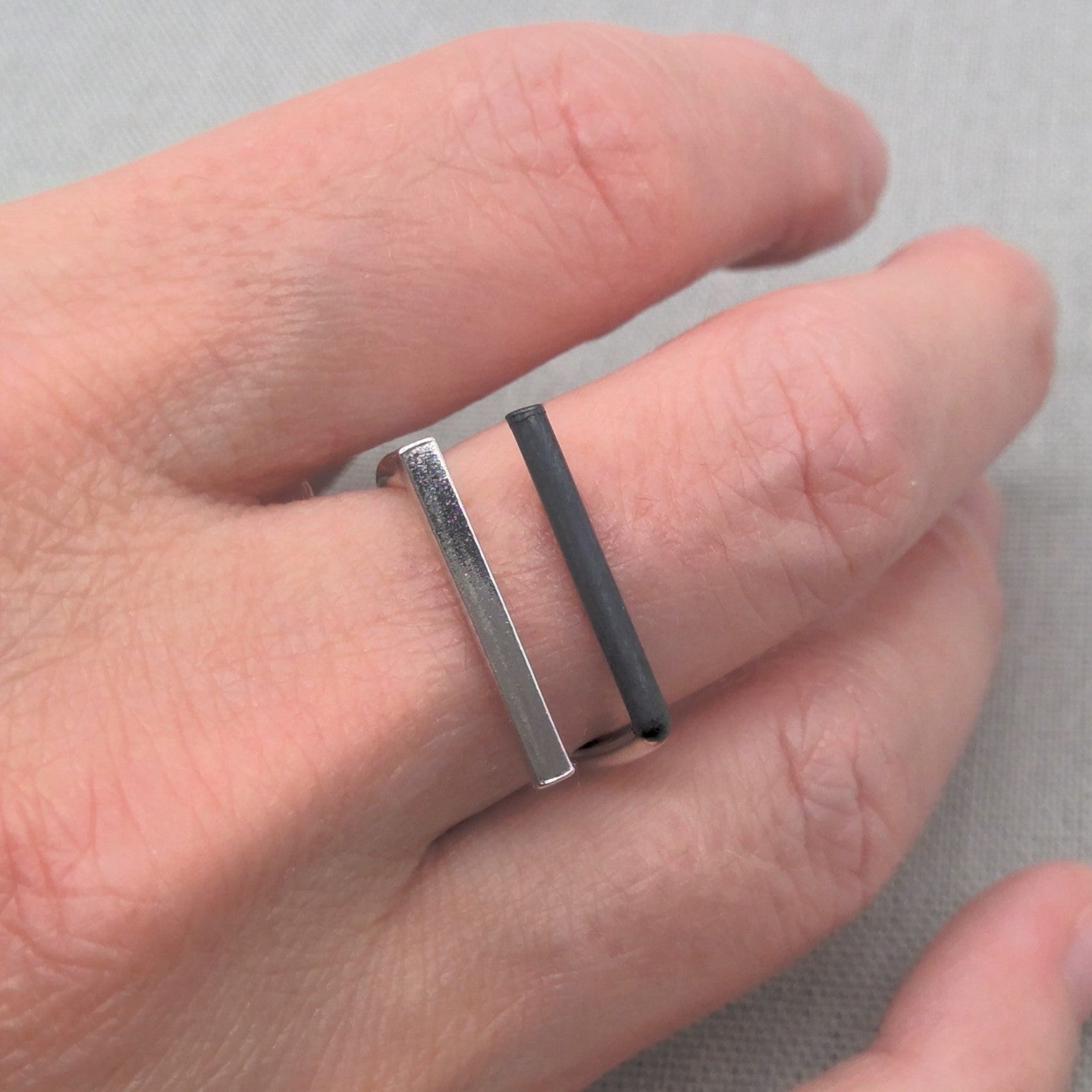 Minimalist recycled silver ring worn stacked on finger
